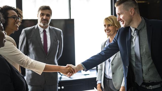 Corporate executives shake hands